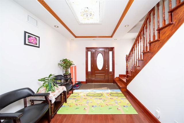 entrance foyer with recessed lighting, wood finished floors, visible vents, stairway, and a raised ceiling