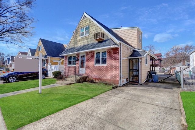 bungalow-style home featuring a front yard, brick siding, fence, and a residential view