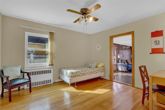 bedroom featuring wood-type flooring and radiator