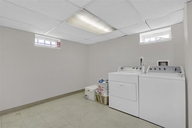 laundry area with laundry area, light floors, independent washer and dryer, and baseboards