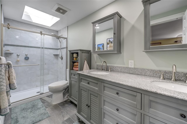 bathroom with double vanity, a sink, visible vents, and a shower stall