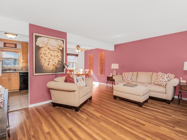 living room featuring light wood finished floors and baseboards