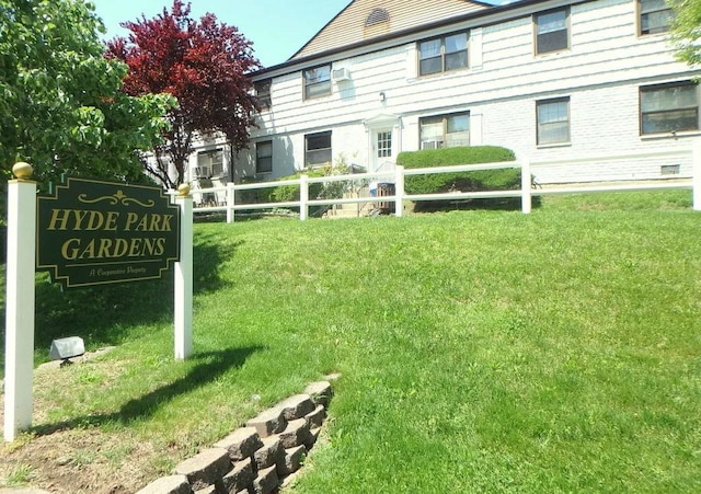 exterior space featuring fence and a lawn