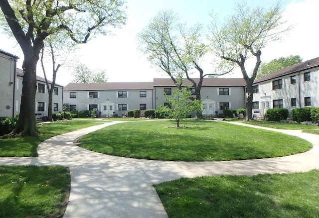 view of community featuring a residential view and a yard