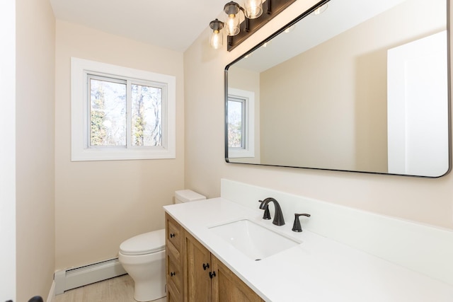 bathroom featuring toilet, a baseboard radiator, baseboards, and vanity