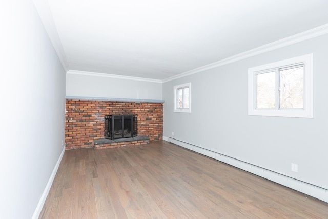 unfurnished living room with a baseboard radiator, wood finished floors, baseboards, a brick fireplace, and crown molding