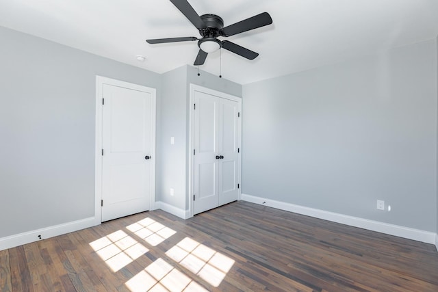 unfurnished bedroom featuring ceiling fan, baseboards, and wood finished floors