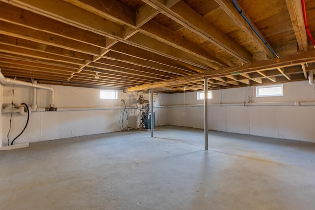 basement with a heating unit and a healthy amount of sunlight