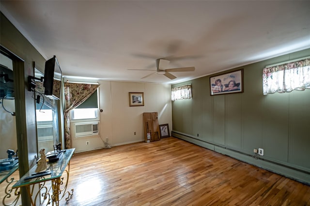 unfurnished room with a baseboard heating unit, plenty of natural light, light wood-style flooring, and ceiling fan