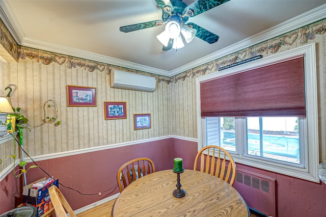 dining room featuring ceiling fan, a wall mounted AC, wainscoting, radiator heating unit, and wallpapered walls