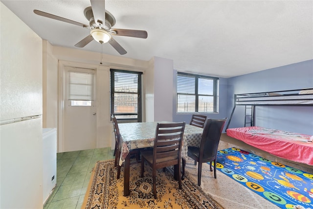 dining space with ceiling fan and a textured ceiling