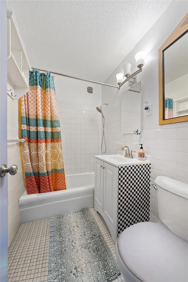 full bathroom with tile walls, shower / bathtub combination with curtain, toilet, a textured ceiling, and tile patterned floors