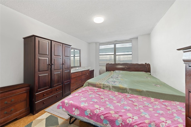 carpeted bedroom featuring a textured ceiling