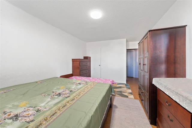 bedroom with a textured ceiling and a closet