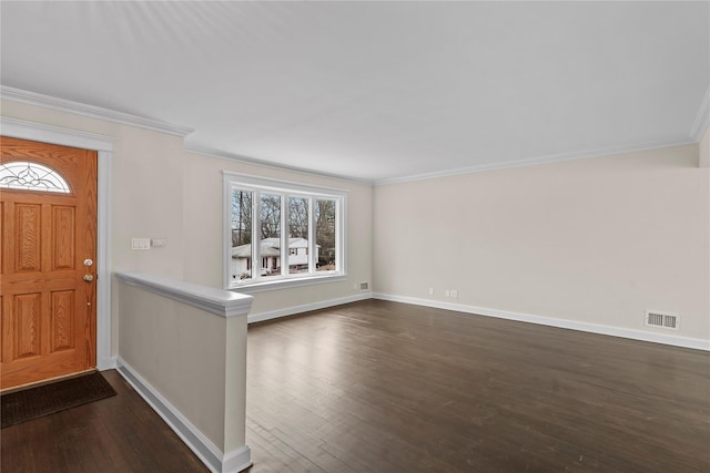 foyer entrance featuring ornamental molding, dark wood-style flooring, visible vents, and baseboards