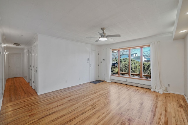 unfurnished room featuring ceiling fan, light wood finished floors, a baseboard radiator, and ornamental molding