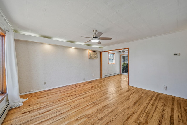 spare room featuring ceiling fan, light wood-type flooring, and a baseboard radiator