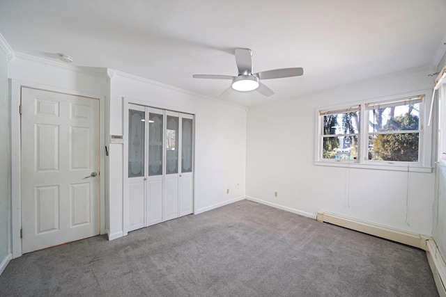 unfurnished bedroom with crown molding, a closet, carpet flooring, ceiling fan, and baseboards