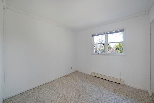 spare room with baseboards, a baseboard heating unit, and carpet flooring