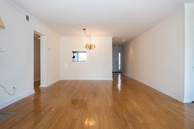 unfurnished room with a chandelier, visible vents, crown molding, and light wood-style floors