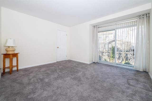 spare room featuring baseboards and carpet floors