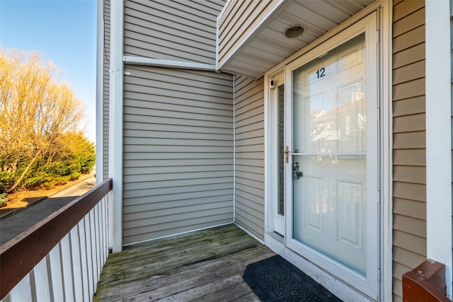 view of exterior entry with a balcony
