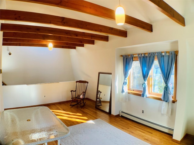 interior space with baseboard heating, wood finished floors, and beam ceiling