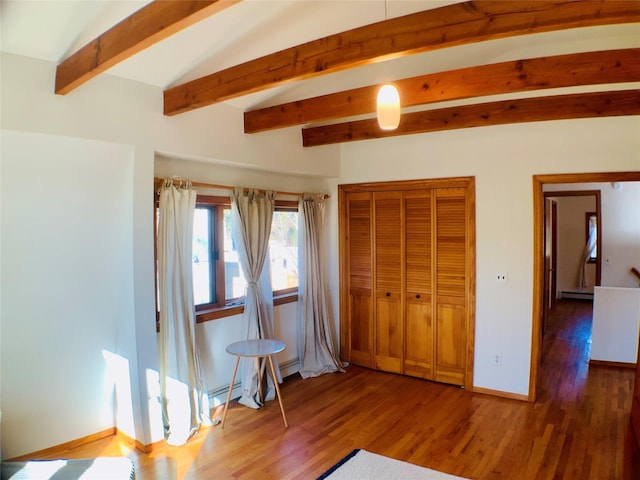 bedroom featuring a baseboard heating unit, baseboards, and wood finished floors