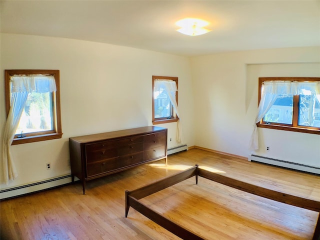 interior space with a baseboard radiator and light wood-style floors