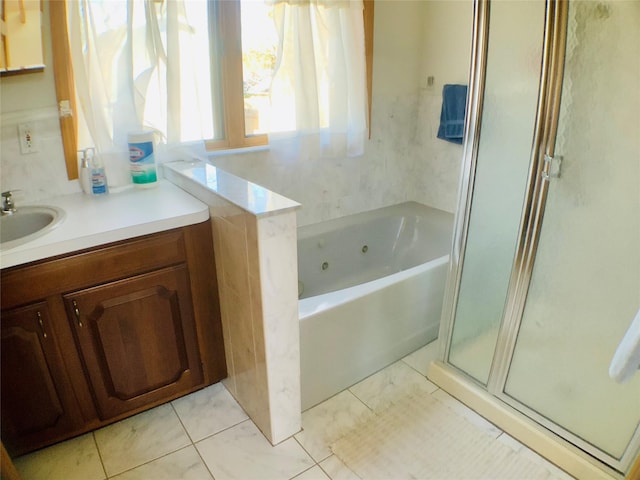 bathroom featuring a whirlpool tub, tile patterned flooring, a shower stall, and vanity