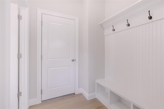 mudroom featuring light wood-style floors and baseboards