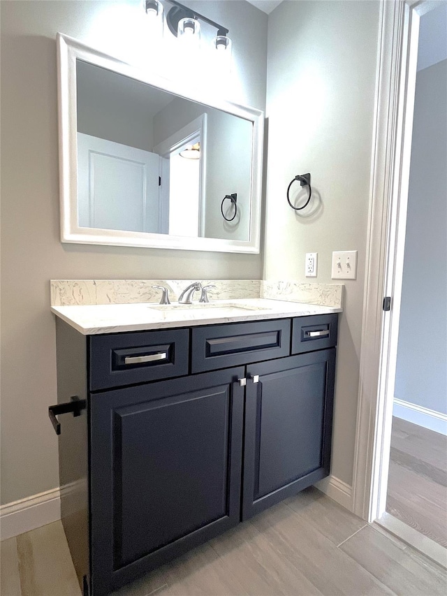 bathroom featuring vanity and baseboards