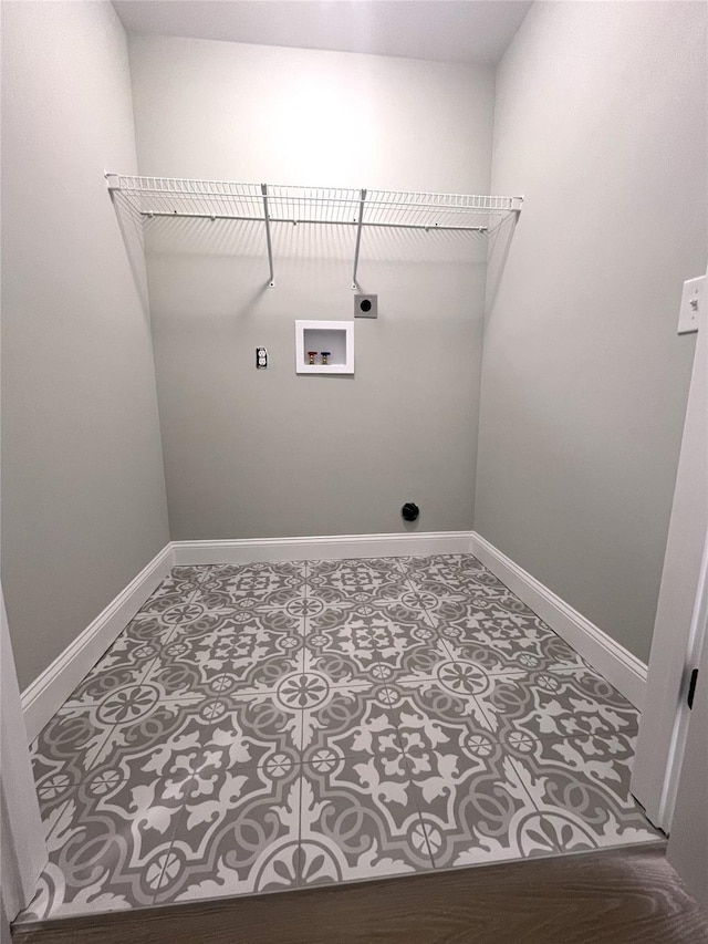 clothes washing area featuring washer hookup, hookup for an electric dryer, tile patterned flooring, laundry area, and baseboards