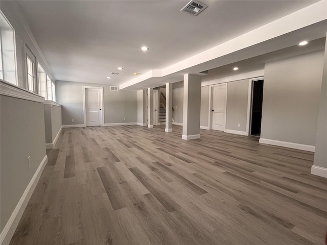 interior space with recessed lighting, wood finished floors, visible vents, baseboards, and stairway