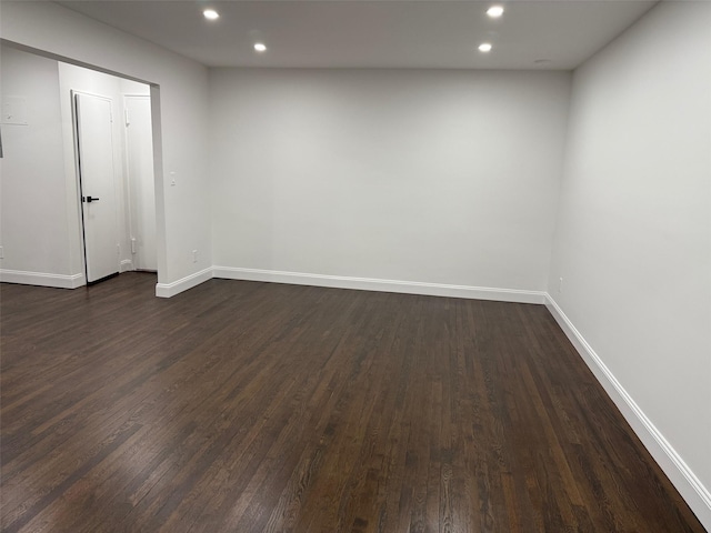 unfurnished room featuring dark wood-style flooring, recessed lighting, and baseboards