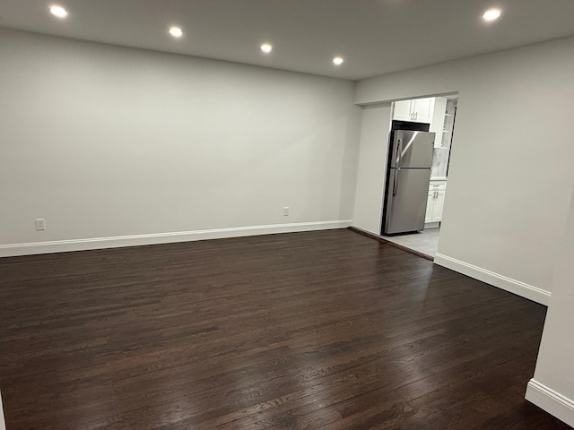 unfurnished room featuring recessed lighting, baseboards, and wood finished floors