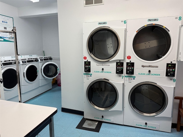 shared laundry area featuring visible vents, separate washer and dryer, stacked washer / dryer, and tile patterned floors