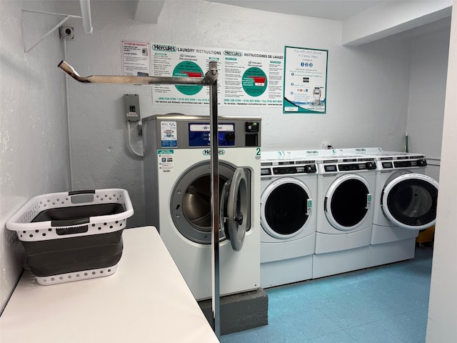 shared laundry area with washer and dryer and a textured wall