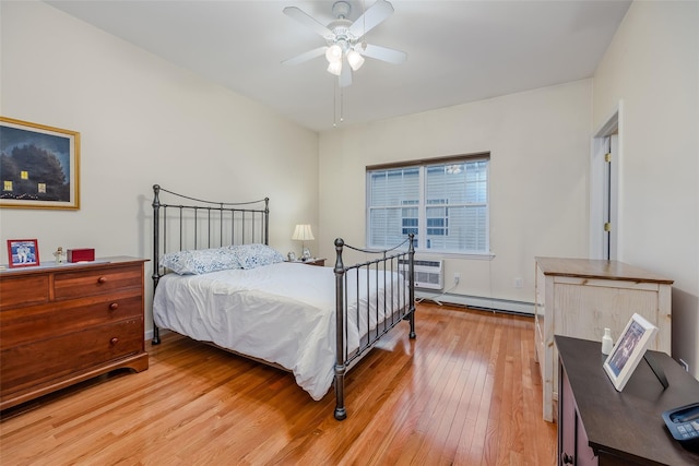 bedroom featuring a wall unit AC, light wood-style floors, ceiling fan, and a baseboard heating unit