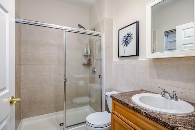 full bathroom with a shower stall, toilet, and tile walls