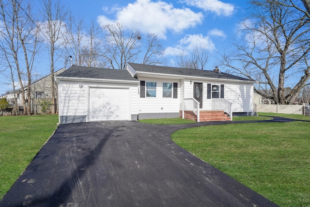 view of front of property with an attached garage, fence, driveway, a chimney, and a front yard