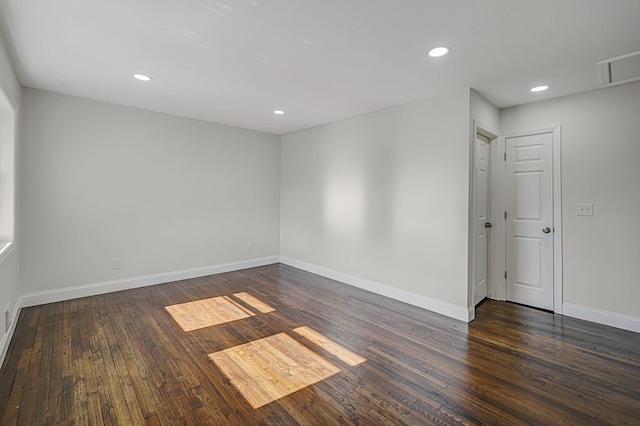 unfurnished room featuring baseboards, dark wood-style flooring, and recessed lighting