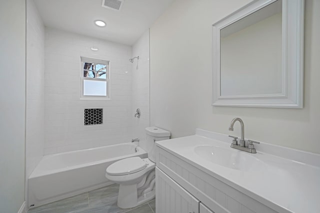 bathroom with shower / bath combination, visible vents, vanity, and toilet