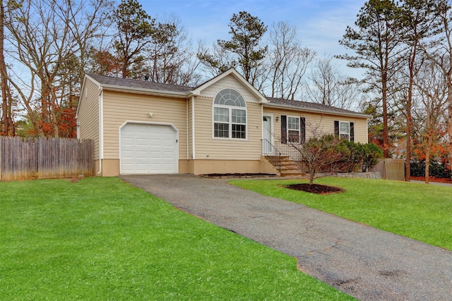 ranch-style house with a garage, a front yard, fence, and aphalt driveway