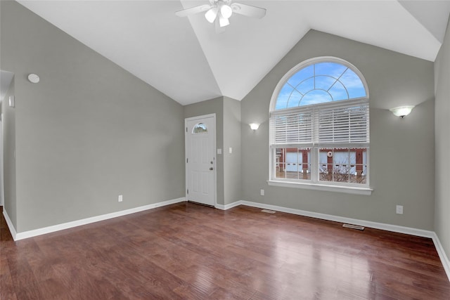 foyer with ceiling fan, vaulted ceiling, baseboards, and wood finished floors