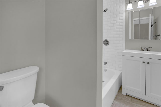 bathroom with toilet, vanity, and bathing tub / shower combination