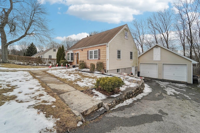 view of front of property featuring a garage, fence, and an outdoor structure