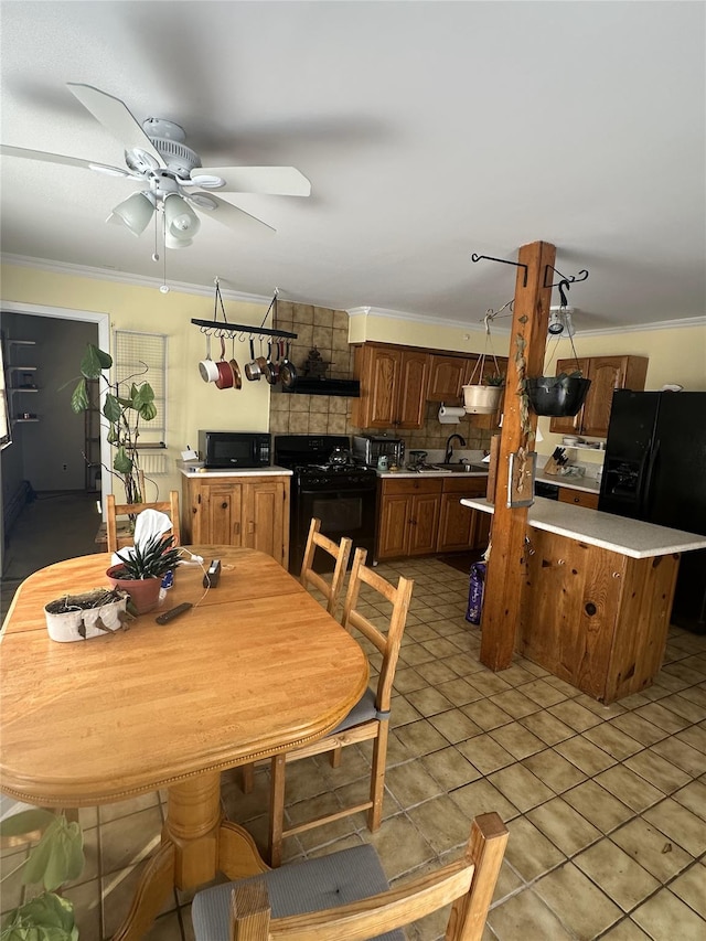 dining area with ceiling fan, crown molding, and light tile patterned flooring