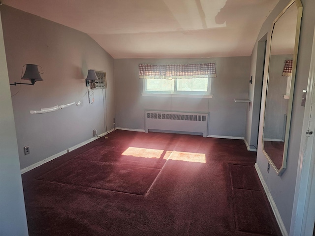 unfurnished room with baseboards, radiator, lofted ceiling, a wall mounted air conditioner, and carpet