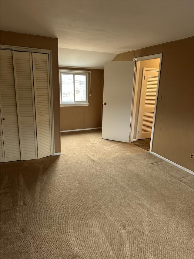 unfurnished bedroom featuring carpet floors and a closet